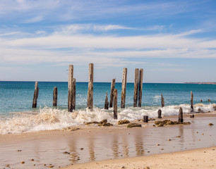Old wooden pier posts at Port Willunga beach, Adelaid, South Australia