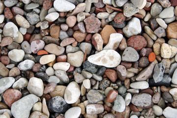 Lot of pebble on the beach background