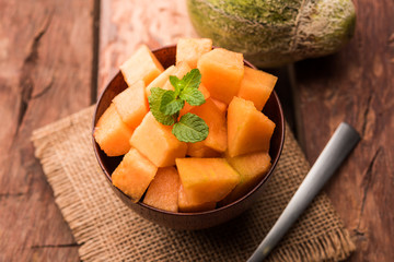 Cantaloupe / muskmelon / kharbuja cut into pieces, served in a bowl. selective focus