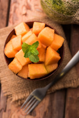 Cantaloupe / muskmelon / kharbuja cut into pieces, served in a bowl. selective focus