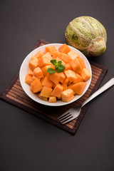 Cantaloupe / muskmelon / kharbuja cut into pieces, served in a bowl. selective focus