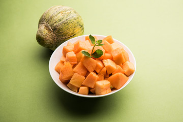 Cantaloupe / muskmelon / kharbuja cut into pieces, served in a bowl. selective focus
