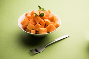 Cantaloupe / muskmelon / kharbuja cut into pieces, served in a bowl. selective focus