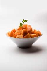 Cantaloupe / muskmelon / kharbuja cut into pieces, served in a bowl. selective focus