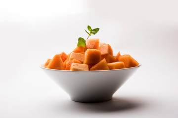 Cantaloupe / muskmelon / kharbuja cut into pieces, served in a bowl. selective focus