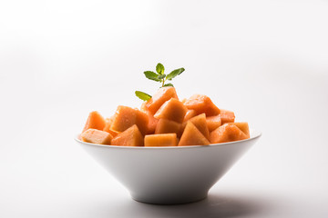 Cantaloupe / muskmelon / kharbuja cut into pieces, served in a bowl. selective focus