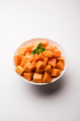 Cantaloupe / muskmelon / kharbuja cut into pieces, served in a bowl. selective focus