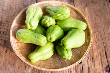 Fresh chayote fruits (Sechium edulis) on wood background