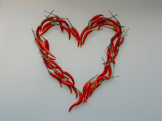Close-up of Heart, symbol of love, designed from red hot chili cayenne peppers handful 