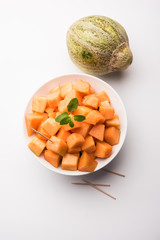 Cantaloupe / muskmelon / kharbuja cut into pieces, served in a bowl. selective focus