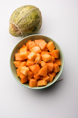 Cantaloupe / muskmelon / kharbuja cut into pieces, served in a bowl. selective focus