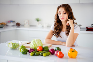 Portrait of her she nice-looking attractive lovely sad frustrated wavy-haired girl housekeeper making difficult house work fresh lunch dinner farm organic vegs in light white interior room