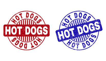 Grunge HOT DOGS round stamp seals isolated on a white background. Round seals with grunge texture in red and blue colors. Vector rubber overlay of HOT DOGS tag inside circle form with stripes.