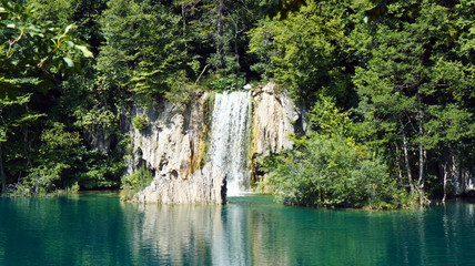Fototapeta na wymiar Waterfall and mountain, beautiful nature landscape, Plitvice Lakes in Croatia, National Park, sunny day