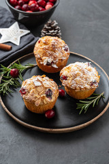Muffins, cakes with cranberry, rosemary and almond nuts. Christmas decoration. Copy space.