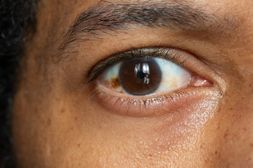 Closeup view of the brown iris in the eye of an Asian male