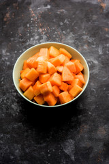 Cantaloupe / muskmelon / kharbuja cut into pieces, served in a bowl. selective focus