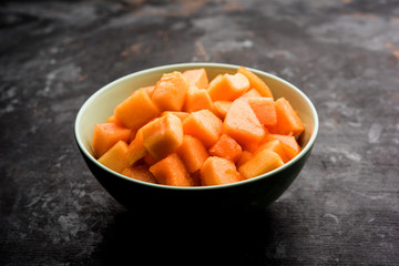 Cantaloupe / muskmelon / kharbuja cut into pieces, served in a bowl. selective focus