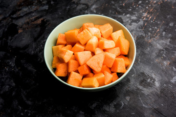 Cantaloupe / muskmelon / kharbuja cut into pieces, served in a bowl. selective focus