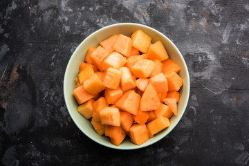 Cantaloupe / muskmelon / kharbuja cut into pieces, served in a bowl. selective focus