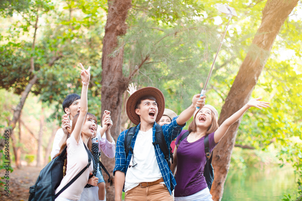 Wall mural happy young group taking selfie by smart phone