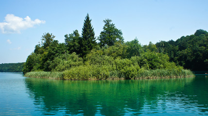 Fototapeta na wymiar Crystal water and landscape with trees, Plitvice Lakes in Croatia, National Park, sunny day