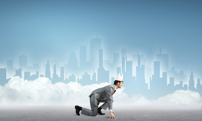 King businessman in elegant suit running and blue cityscape silhouette at background