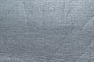 Surface of soft porous packaging film or material. Film gray. Texture with vertical, horizontal and diagonal lines at the bend points. Background, backdrop. Modern packaging material.