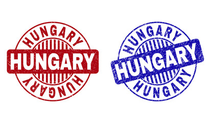 Grunge HUNGARY round stamp seals isolated on a white background. Round seals with distress texture in red and blue colors. Vector rubber watermark of HUNGARY title inside circle form with stripes.