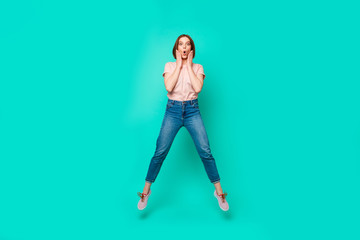 Full length body size photo beautiful her she lady jumping high yell scream shout unexpected free shopping hands arms cheeks wear casual jeans denim pastel t-shirt isolated teal turquoise background