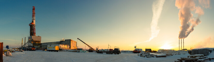 drilling rig on land winter morning panorama work on well cementing