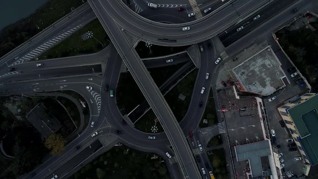 Fly over road interchange in city. Aerial view , drone camera smooth rotation around.