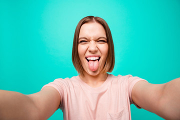 Close up photo beautiful her she lady tongue out mouth foolish playful mood short straight hair make take selfies instagram post followers likes wear casual t-shirt isolated teal turquoise background