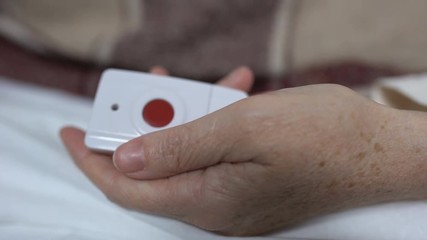 Female patient pushing nurse call button or taking extra dose of pain reliever