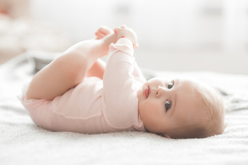 Adorable little baby portrait. Cute baby girl indoor. 6 month child smiling. - obrazy, fototapety, plakaty