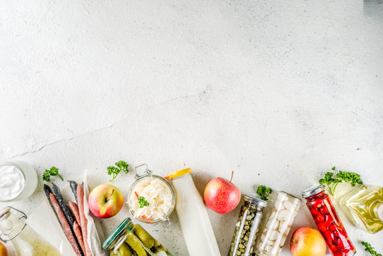 Assortment Of Various Fermented Food - Apple Cider Vinegar, Fermented Meat And Vegetables,  Sauerkraut, Pickled Peppers, Tomatoes, Garlic, Capers, White Background Copy Space