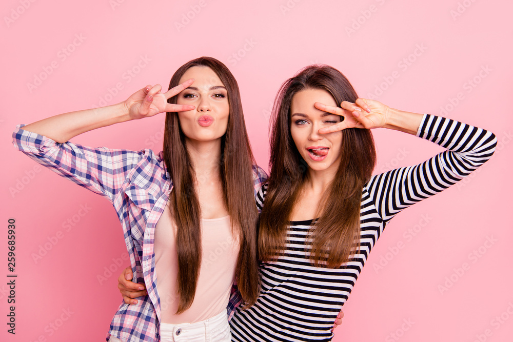 Wall mural Portrait of nice-looking attractive lovely winsome flirty cheerful cheery straight-haired girls wearing casual showing v-sign near eyes having fun isolated over pink pastel background