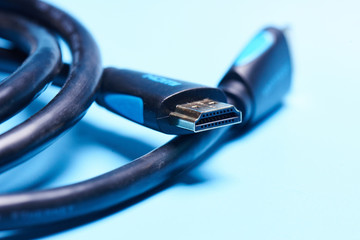 Black HDMI cable adapter connector on a blue background isolated