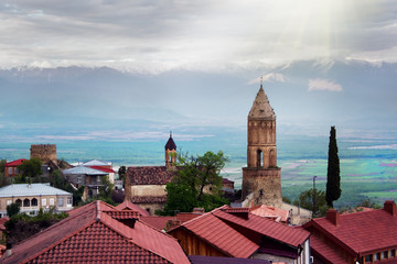 Scenic view on a roofs of ancient buildings of Sighnaghi, Georgia. Alazani Valley and Caucasus mountain range