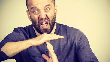 Man showing time stop gesture