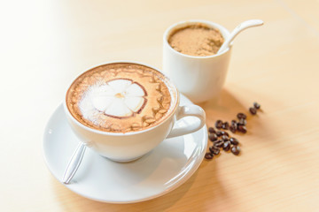 hot cappuccino coffee with nice pattern foam on table
