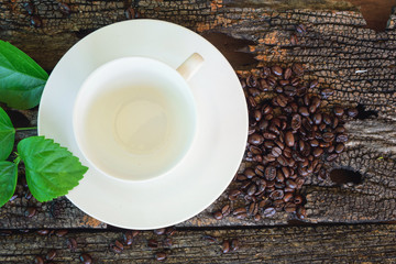 empty cup with coffee bean on wood plate