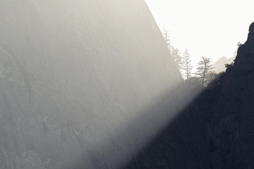 Dramatic light beams cut through thick haze