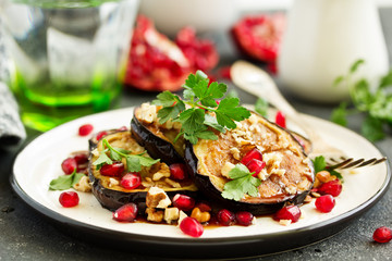 Fried eggplants with pomegranate sauce and nuts.