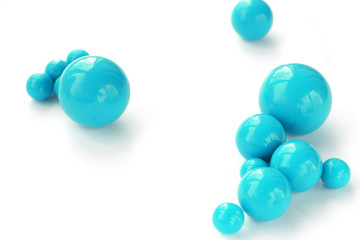 Abstract background of plastic blue beads of different sizes on a white background. copy space..
