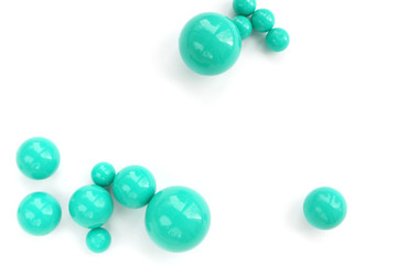 Abstract background of plastic green beads of different size on a white background. copy space...