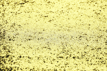 background and texture gold shiny fabric with a large glitter sparkles in the sun..