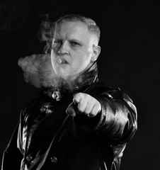 Portrait of handsome man with a cigar in leather jacket