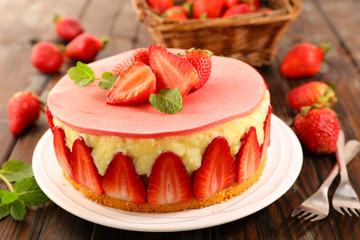 delicious strawberry cake on wood background
