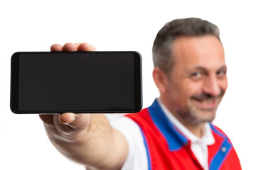 Closeup of phone held by supermarket employee.